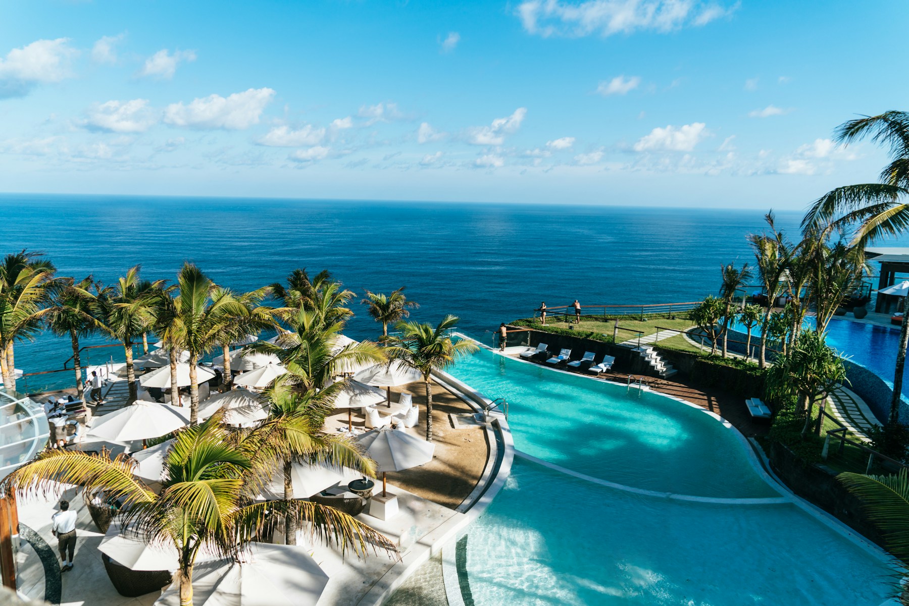 A serene resort pool beside the ocean